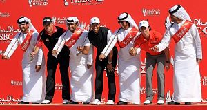 Lee Westwood, Tiger Woods and Rory McIlroy with members of a traditional Emirati Ayala dance group at the Abu Dhabi Golf Club in the United Arab Emirates. Pic: AP