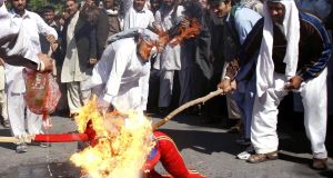 Afghan protestors step on a hand-made U.S. flag during a demonstration in Jalalabad, Afghanistan today.