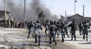 fghan policemen run toward protesters during an anti-US demonstration in Kabul today fghan policemen run toward protesters during an anti-US demonstration in Kabul today