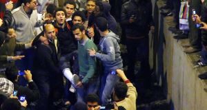 An injured man is carried after arriving from Port Said at a train station in Cairo last Thursday. An injured man is carried after arriving from Port Said at a train station in Cairo last Thursday.