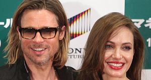 Brad Pitt and Angelina Jolie smiling during a press conference of his latest film, Moneyball. Brad Pitt and Angelina Jolie smiling during a press conference of his latest film, Moneyball.
