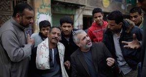 Times journalist Anthony Shadid, middle right, interviews residents in Cairo last year. Picture: New York Times / AP Photo