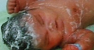 Baby Chun Chun is washed by a nurse at Xinxiang Maternity Hospital, in Xinxiang city, Henan province, China.