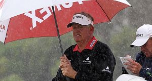 Scotlands Colin Montgomerie shelters from the rain during round one of the Barclays Scottish Open today. Scotlands Colin Montgomerie shelters from the rain during round one of the Barclays Scottish Open today.