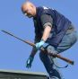 A police officer retrieves the weapon of the gunman from the roof, in the center of Hyvinkaa, Finland