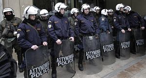 Riot police guard the entrance to the Development Ministry in Athens, which was occupied by protesting PPC electricity company employees today. Pic: AP Riot police guard the entrance to the Development Ministry in Athens, which was occupied by protesting PPC electricity company employees today. Pic: AP