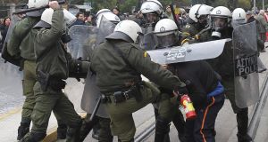 Riot police clash with protesters in Athens yesterday