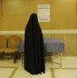 An Iranian woman checks the list of the candidates in the parliamentary runoff elections at a polling station in Tehran yesterday.