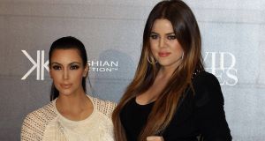 Celebrities Kim Kardashian, left, and sister Khloe arrive for a launch of their fashion accessory range at a department store in Sydney, Australia today.