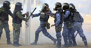 Maldives soldiers, left, are involved in a clash with police officers, right, in Male, Maldives, today. Pic: AP