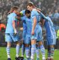 Edin Dzeko (second right) celebrates with team-mates after scoring his teams second goal
