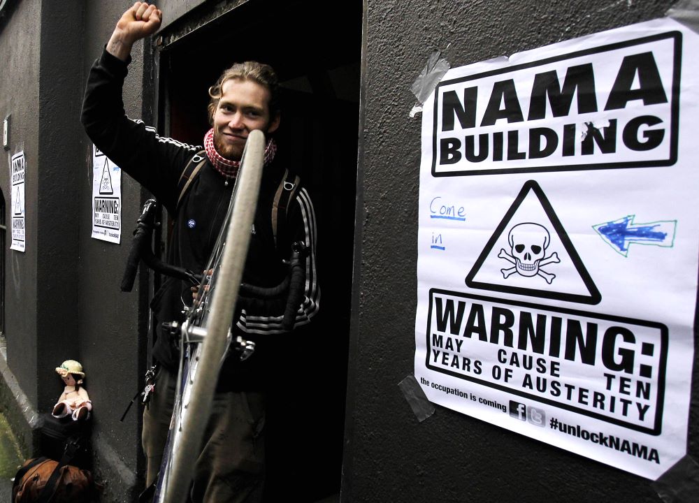 An unnamed member of Unlock NAMA leaves an occupied building on Dublin's Great Strand Street.
