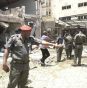 A police officer points at the site of a bomb explosion at the offices of the influential newspaperThisDay in Nigeria’s capital Abuja