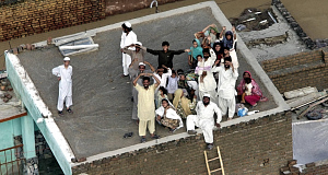 Stranded Pakistani villagers wait for rescue helicopters on roof of their house in Nowshera, Pakistan yesterday. Pic: AP Stranded Pakistani villagers wait for rescue helicopters on roof of their house in Nowshera, Pakistan yesterday. Pic: AP