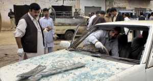 Pakistani security officials examine a damaged car at the site of of suicide bombing in Adazai town near Peshawar, Pakistan. Pakistani security officials examine a damaged car at the site of of suicide bombing in Adazai town near Peshawar, Pakistan.