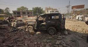 Damaged vehicles remain at the site of the car bombing in Lahore, Pakistan today.