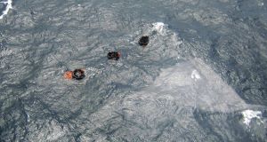Three life rafts from the MV Rabaul Queen are seen floating above the sunken hull of the ferry in the open waters off Papua New Guinea
