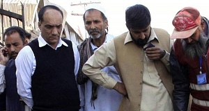 People gather at the spot of a suicide bombing outside a courthouse in Peshawar, Pakistan today. People gather at the spot of a suicide bombing outside a courthouse in Peshawar, Pakistan today.