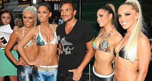 Singer Peter Andre appeared to put troubles with his estranged wife aside as he struck a pose with a group of bikini-clad models.