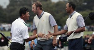 K.J. Choi of South Korea congratulates Tiger Woods on the 16th green