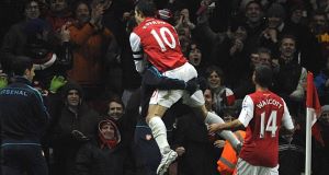 Arsenals Robin Van Persie (centre) celebrates with his teammates after scoring the Gunners third goal from a penalty during todays match. Arsenals Robin Van Persie (centre) celebrates with his teammates after scoring the Gunners third goal from a penalty during todays match.