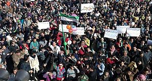 In this citizen journalism image provided by the Local Coordination Committees in Syria, anti-Syrian regime protesters march in Bensh, Idlib Province, northern Syria. In this citizen journalism image provided by the Local Coordination Committees in Syria, anti-Syrian regime protesters march in Bensh, Idlib Province, northern Syria.