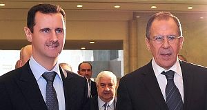 Syrian President Bashar Assad, left, escorts Russian Foreign Minister Sergey Lavrov upon his arrival at the presidential Palace in Damascus, Syria, today.