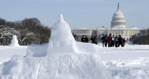 A snow version of the US Capitol appears on the National Mall juxtaposed with the original in Washington.