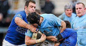 Mark Melbourne, Garryowen, is tackled by Stephen Bradshaw, left, and Philip Brophy, St Marys today Mark Melbourne, Garryowen, is tackled by Stephen Bradshaw, left, and Philip Brophy, St Marys today