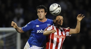 Stoke Citys Tuncay Sanli (right) and Portsmouths Marc Wilson battle for the ball.