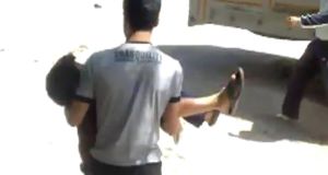 This image made from amateur video released by Shaam News Network purports to show a wounded child being evacuated in Aleppo, Syria (AP Photo/Shaam News Network via AP video).