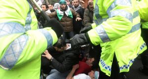 Protesters clash with police outside the Syrian Embassy in central London today. Protesters clash with police outside the Syrian Embassy in central London today.