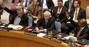 Portuguese representative Jose Filipe Moraes Cabral, left, and South African representative Baso Sangqu, right, glance at Russian representative Vitaly Churkin, center, as they vote today. Portuguese representative Jose Filipe Moraes Cabral, left, and South African representative Baso Sangqu, right, glance at Russian representative Vitaly Churkin, center, as they vote today.